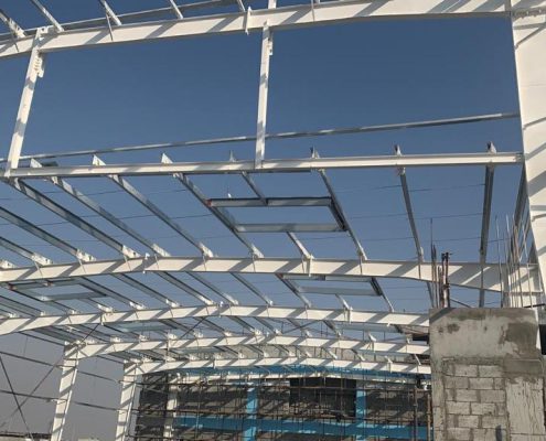 White steel roof frame of a building under construction, prepared for fireproofing