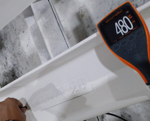 Elcometer dry film thickness gauge measuring intumescent paint thickness on a steel beam