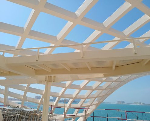 Cream-coated steel lattice canopy structure overlooking the coast in Ras Al Khaimah