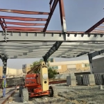 Steel structural frame under construction at a UAE warehouse project site, ready for fireproof coating application