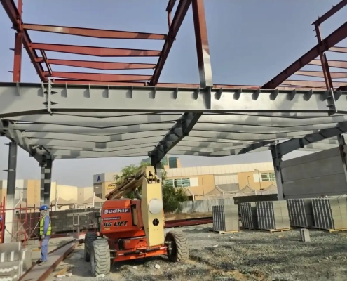 Steel structural frame under construction at a UAE warehouse project site, ready for fireproof coating application