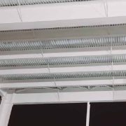 Overhead view of corrugated steel roof deck coated with intumescent fireproofing
