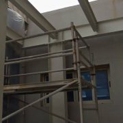 Interior view of steel columns and beams treated with fire retardant coating near scaffolding